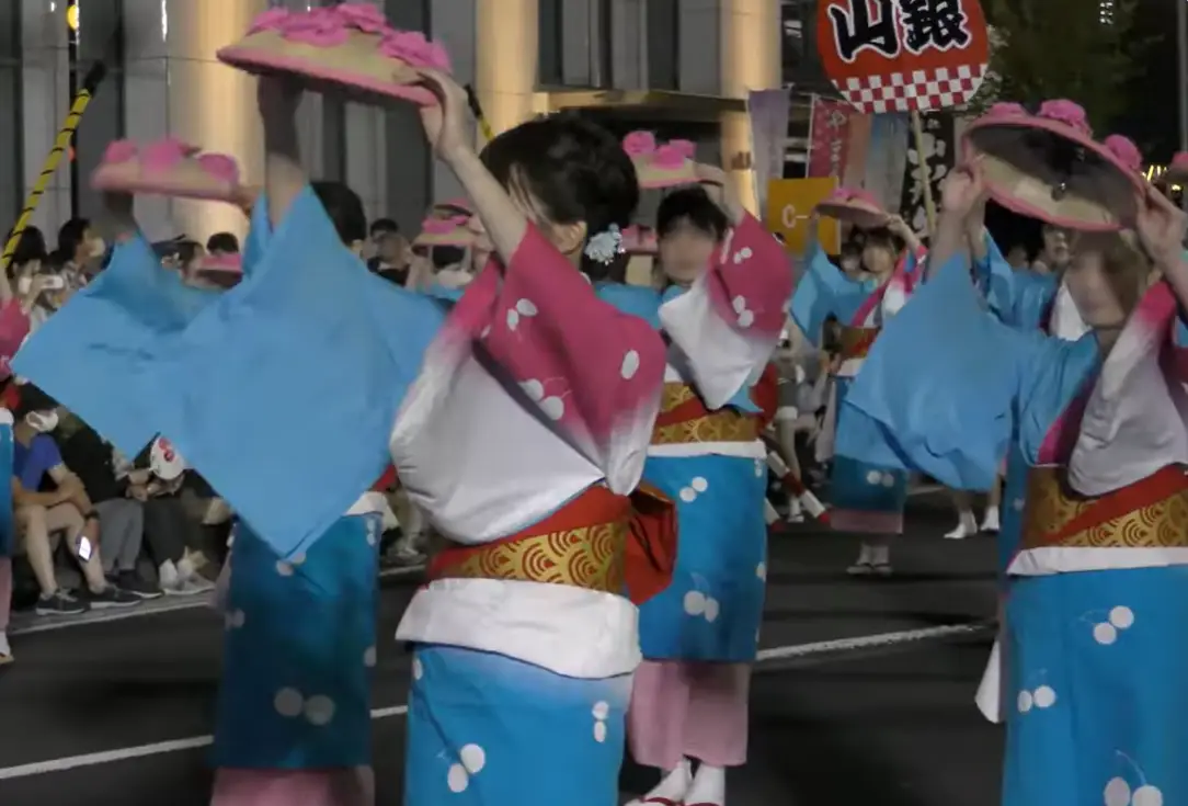 Hanagasa dancers swaying in unison with straw hats adorned with flowers at Yamagata’s summer festival