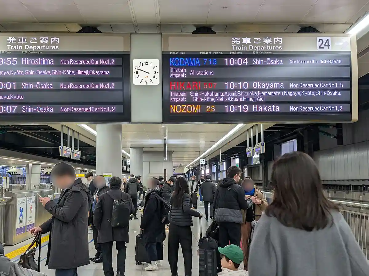 Shinkansen departure board at Shinagawa Station platform showing train times and destinations