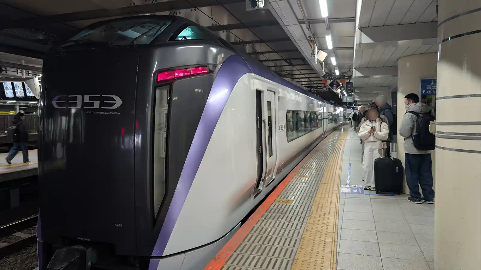 Fuji Excursion limited express train stopping at the platform inside Shinjuku Station before departure to Kawaguchiko