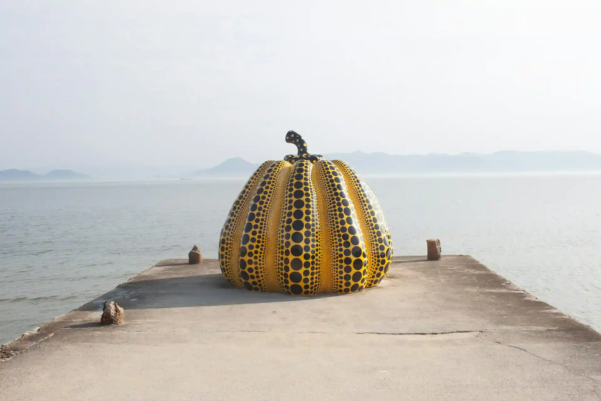 Yayoi Kusama pumpkin sculpture on Naoshima Island placed on a pier facing the Seto Inland Sea