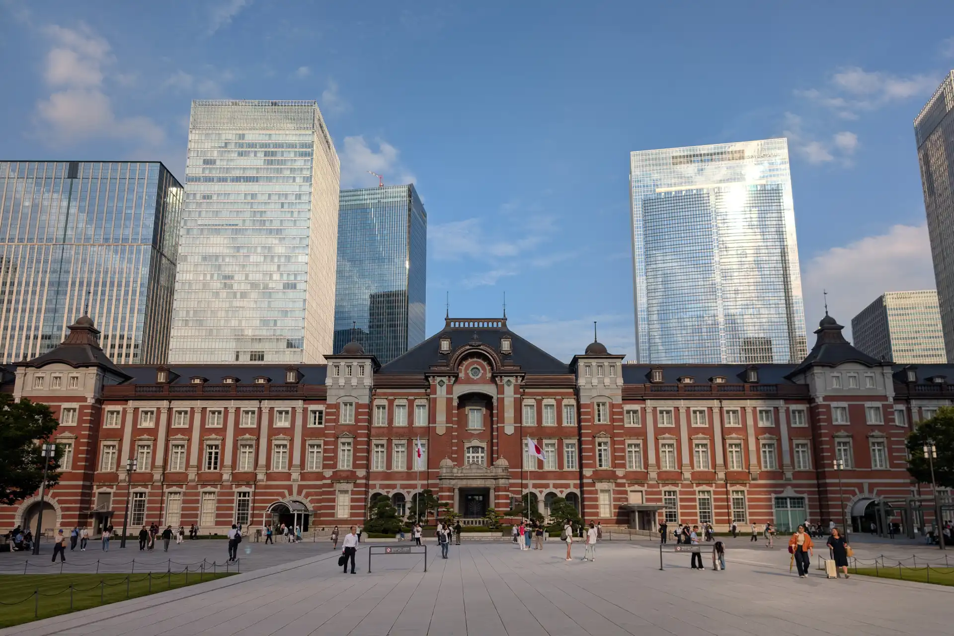 Tokyo Station’s red-brick Marunouchi building with modern skyscrapers in the background