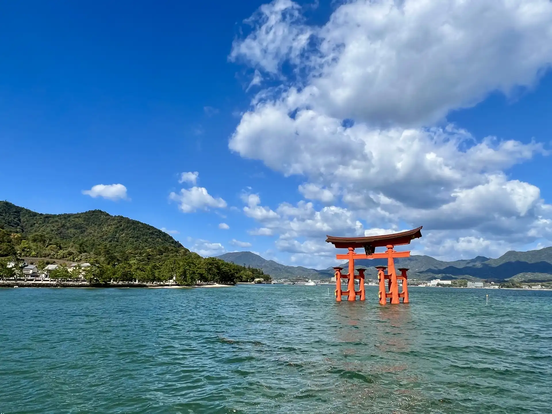 Iconic floating torii gate of Itsukushima Shrine on Miyajima Island, with scenic ocean and mountain views in Hiroshima