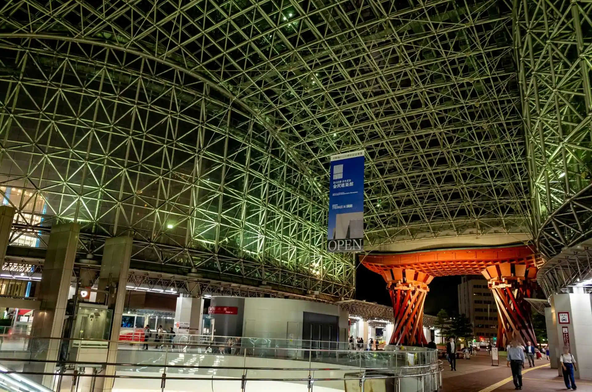 Kanazawa Station East Exit with the illuminated Tsuzumi-mon Gate beneath the Motenashi Dome at night