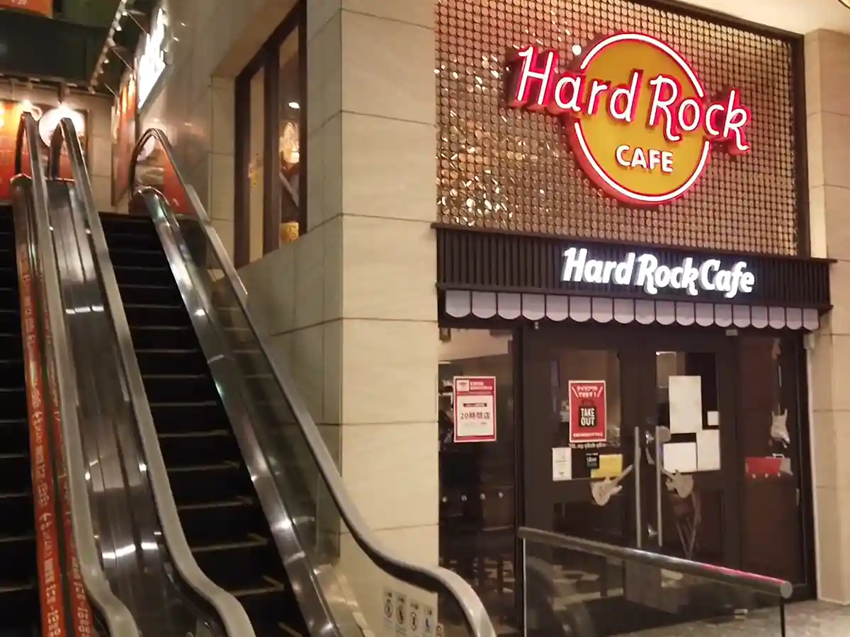 Hard Rock Cafe entrance inside Atre at JR Ueno Station with an escalator nearby