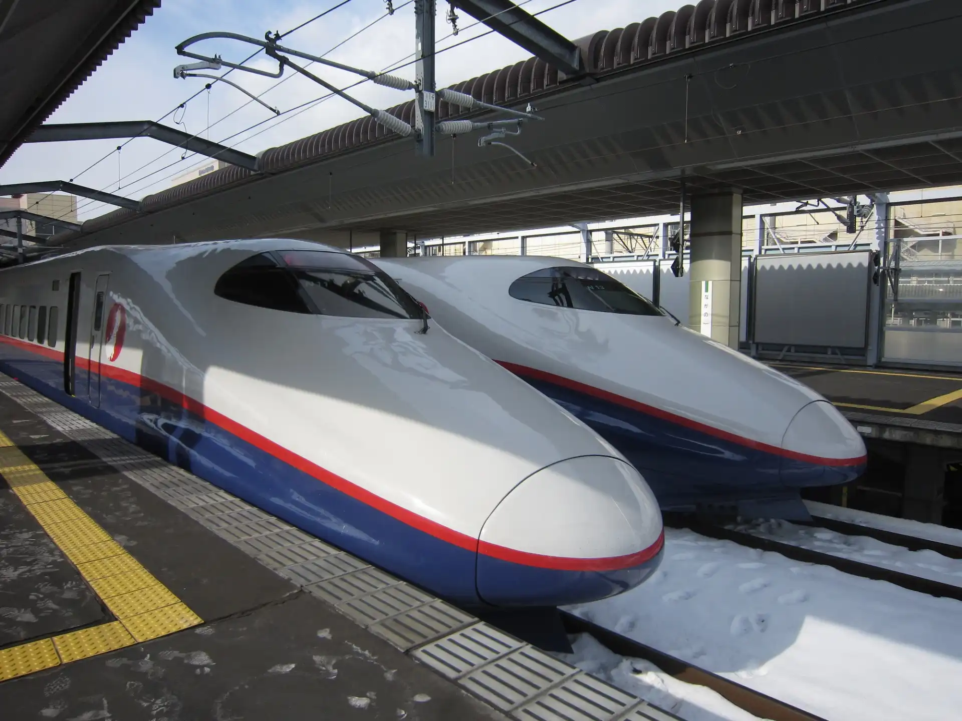 Close-up view of Hokuriku Shinkansen Asama trains at Nagano Station platform