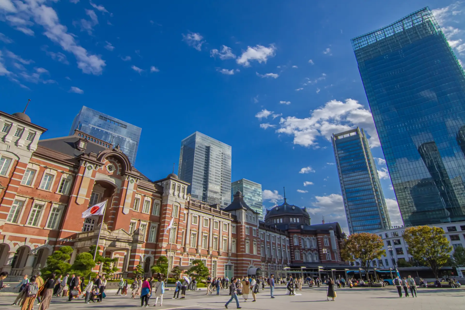 Red-brick Tokyo Station Marunouchi facade with modern skyscrapers in Chiyoda business district