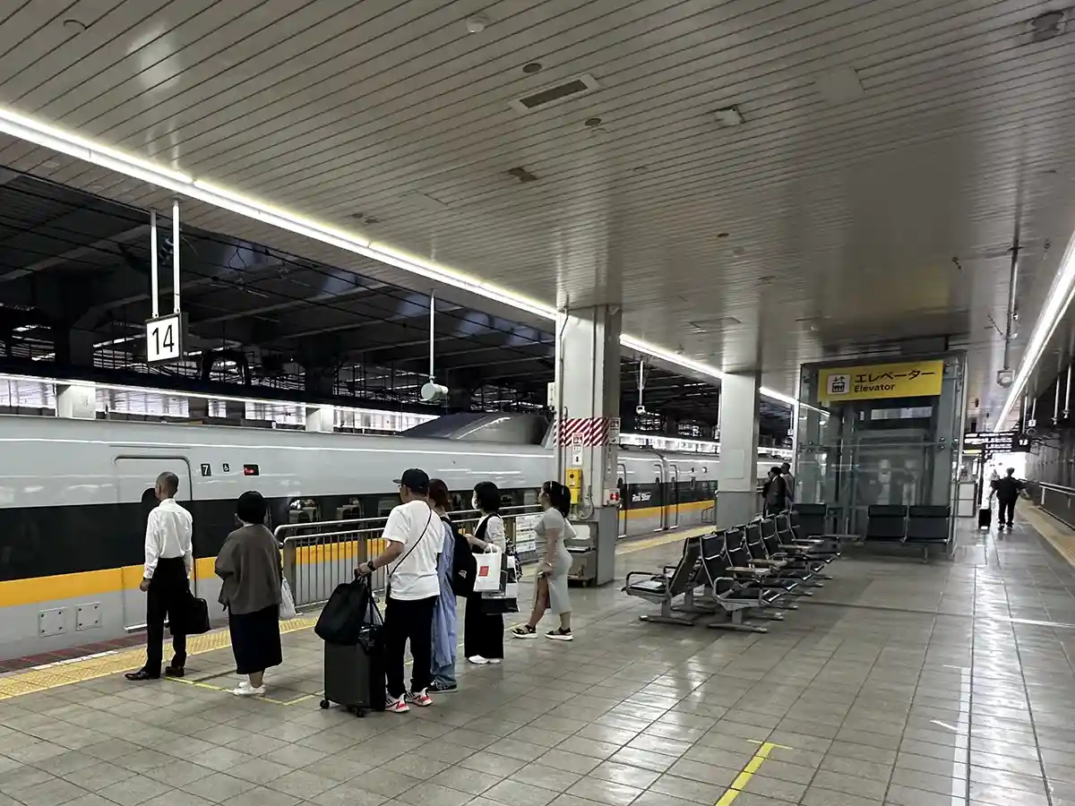 Passengers waiting in line to board the Shinkansen on the platform at Hakata Station