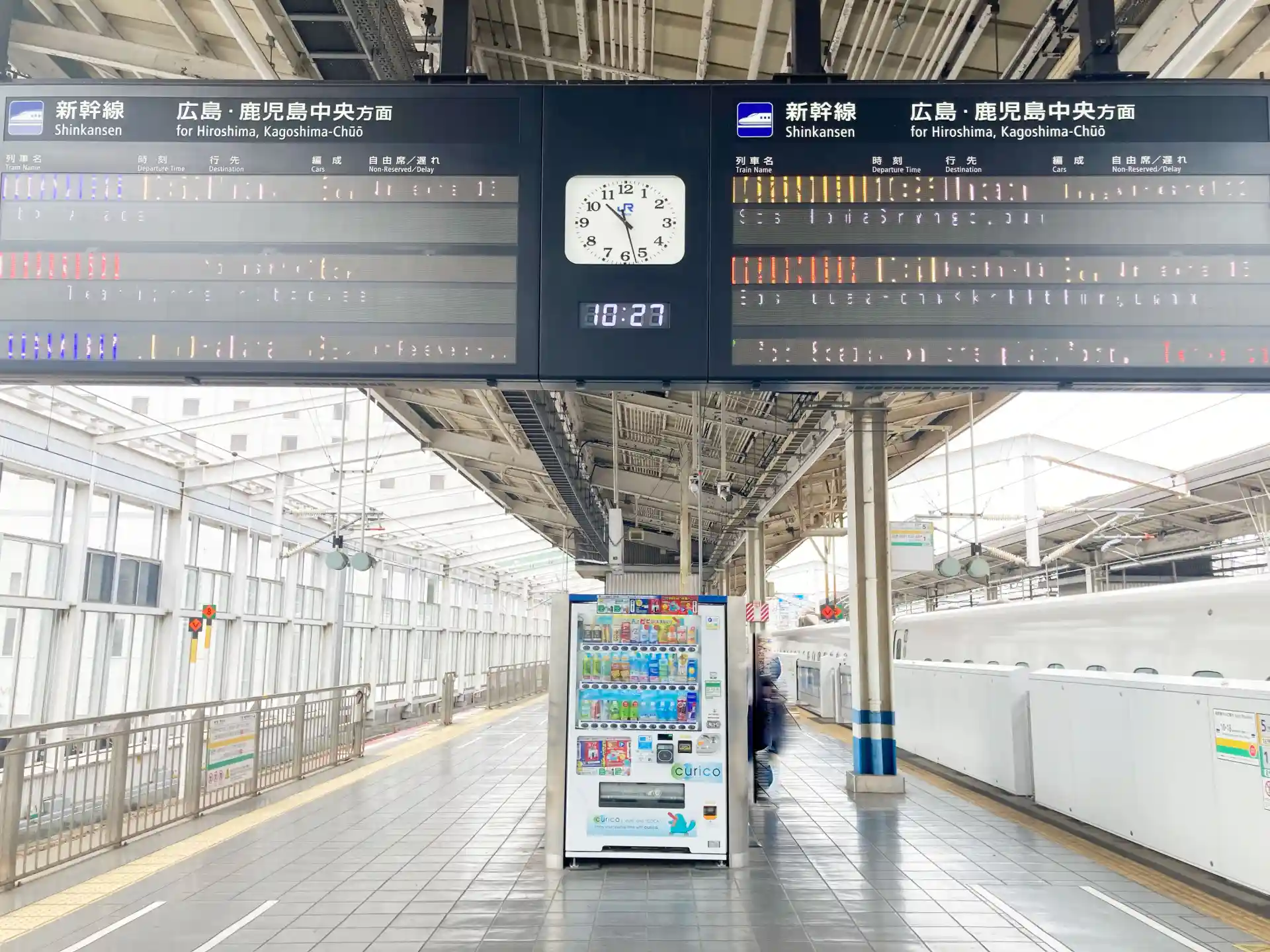 Shinkansen platform at Okayama Station for Hiroshima and Kagoshima Chuo services with departure boards