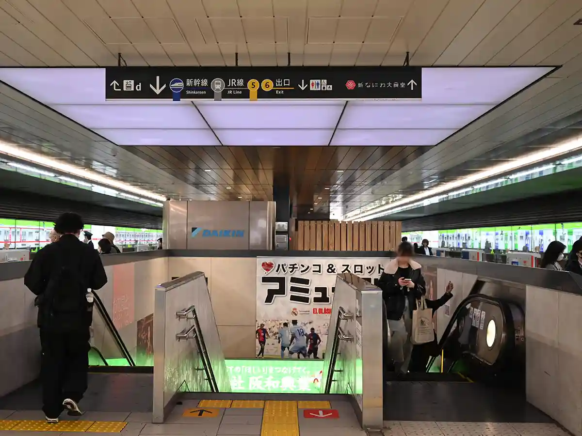 Escalators at Shin-Osaka Station leading from Midosuji Line platform toward Shinkansen and JR lines