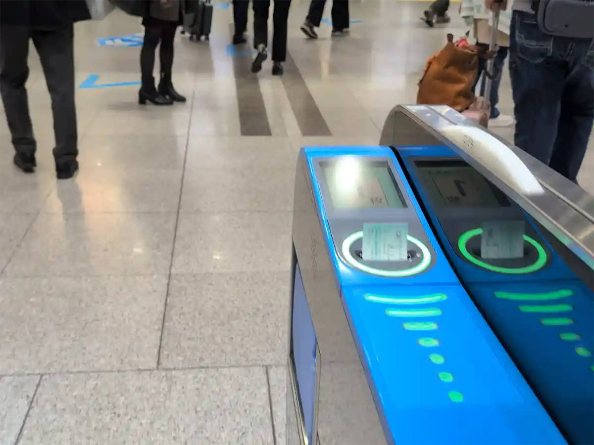 Close-up of ticket being returned from gate machine at Shinagawa Station south transfer area