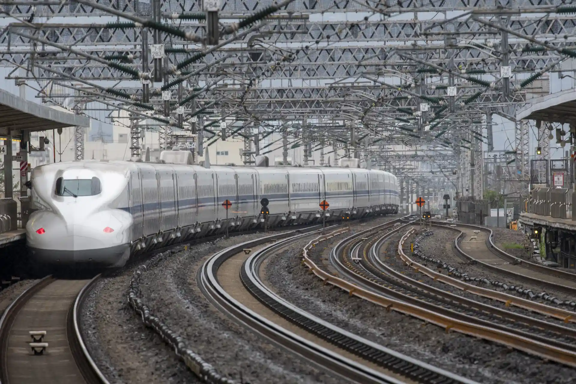 Sanyo Shinkansen traveling near Okayama Station on curved tracks toward large city destinations