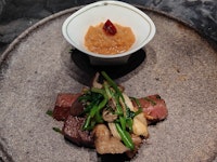 Stir-fried snow-aged beef from Niigata Prefecture, Kanazawa parsley from Ishikawa Prefecture, and oyster mushrooms, served with grated daikon radish with Japanese pepper