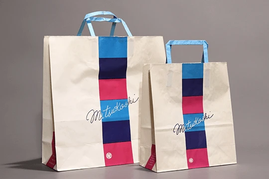 三越, 一般用（旧デザイン）　やなせたかしによる筆記体と独特な色面が特徴。系列の地方百貨店にもこのデザインが展開され、日本全国で見ることができた。