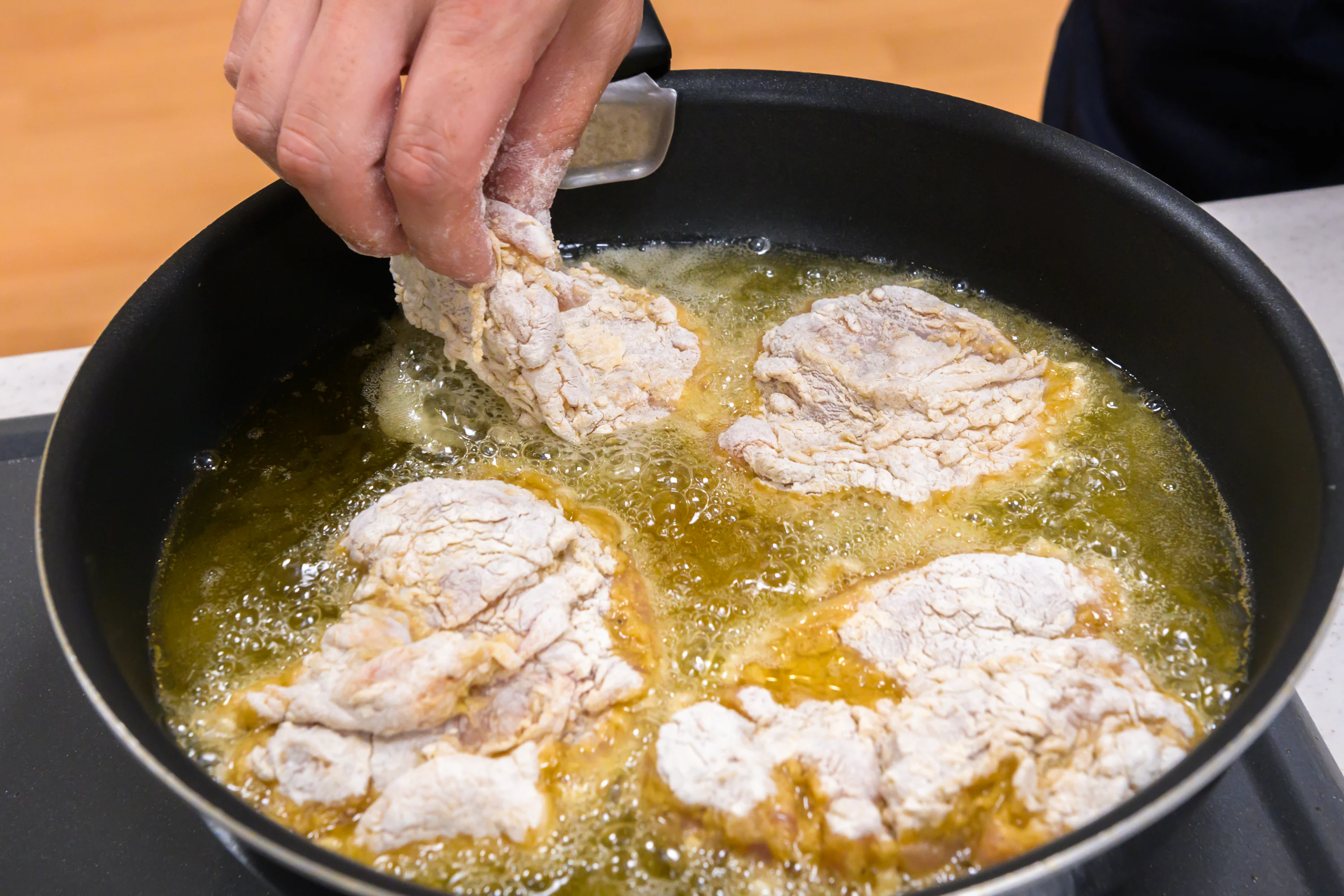 鶏肉を揚げ油に入れた様子