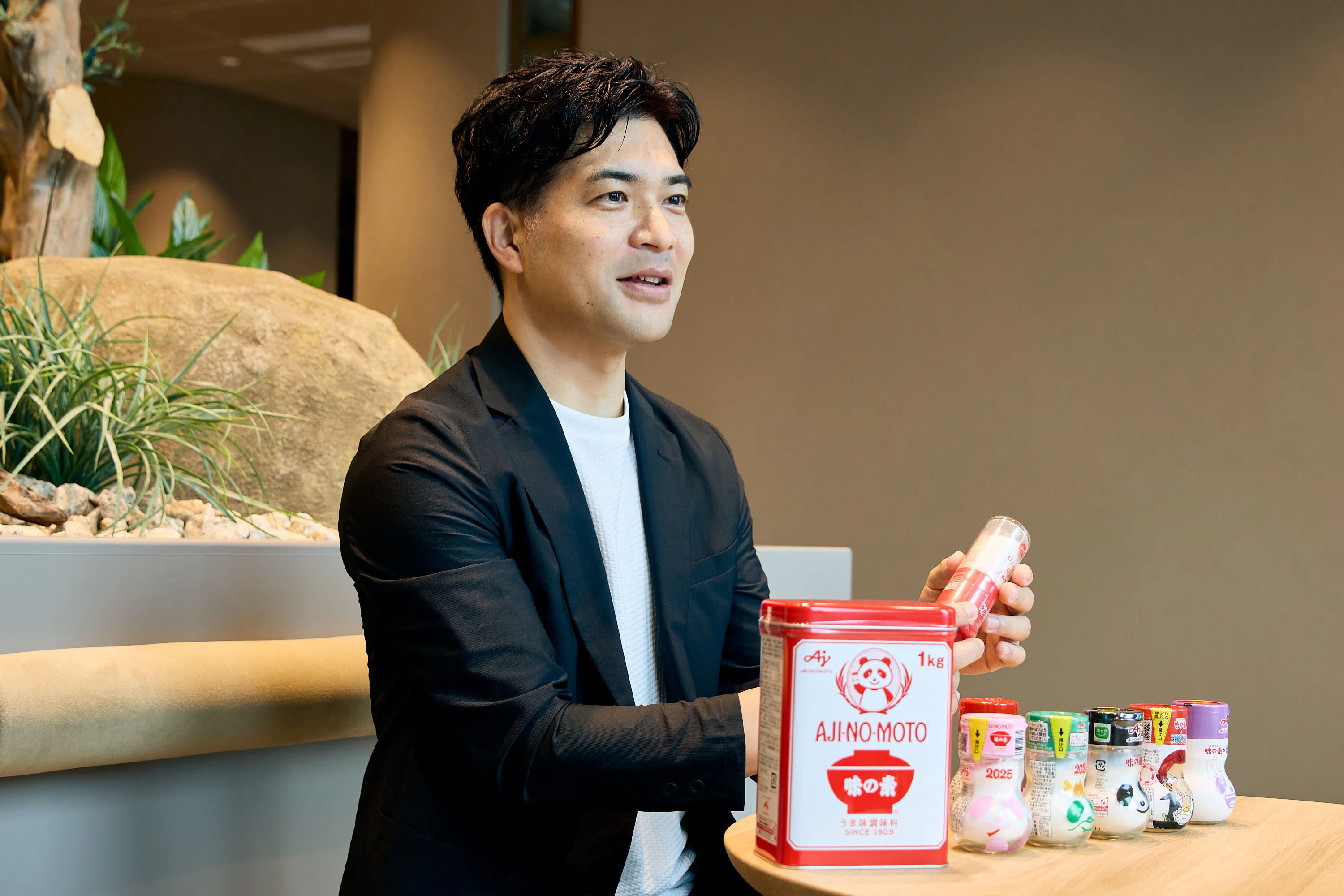 宮坂さんが味の素®の瓶を持ちながら話す様子