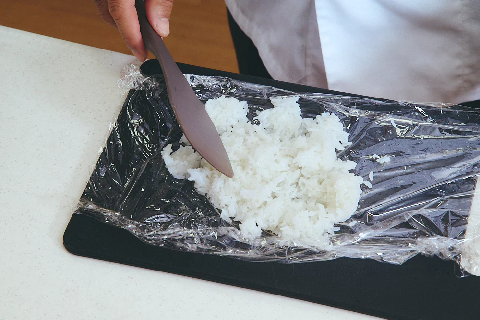 ラップの上にご飯を敷いている様子