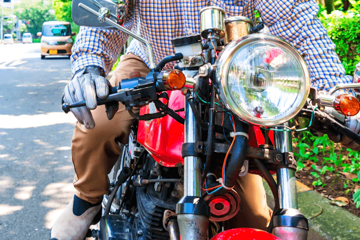 赤いバイクに乗る男性