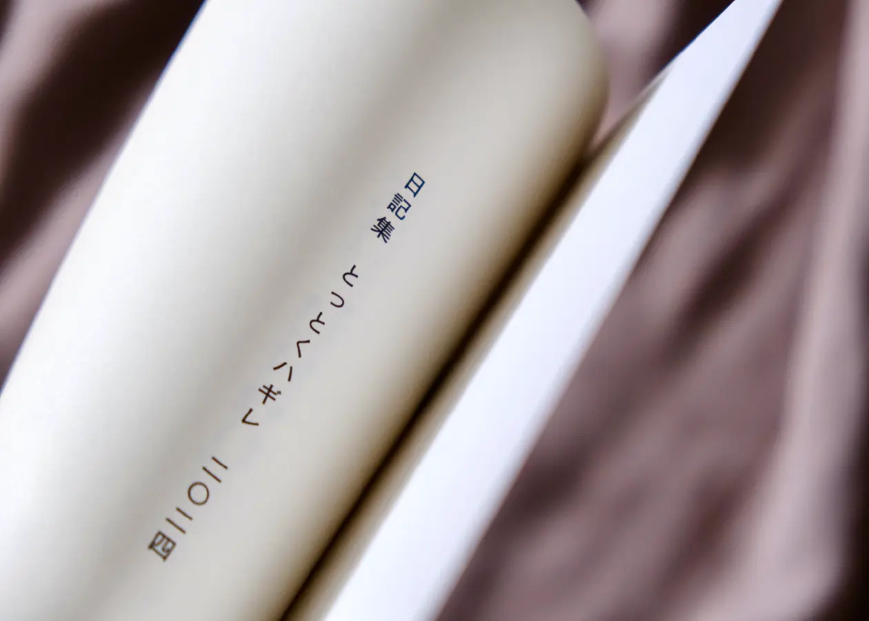 日記集『とっとくハギレ 2024』1ページ目の画像。本が少しだけ開かれており、日記集『とっとくハギレ 2024』というタイトルが見える。