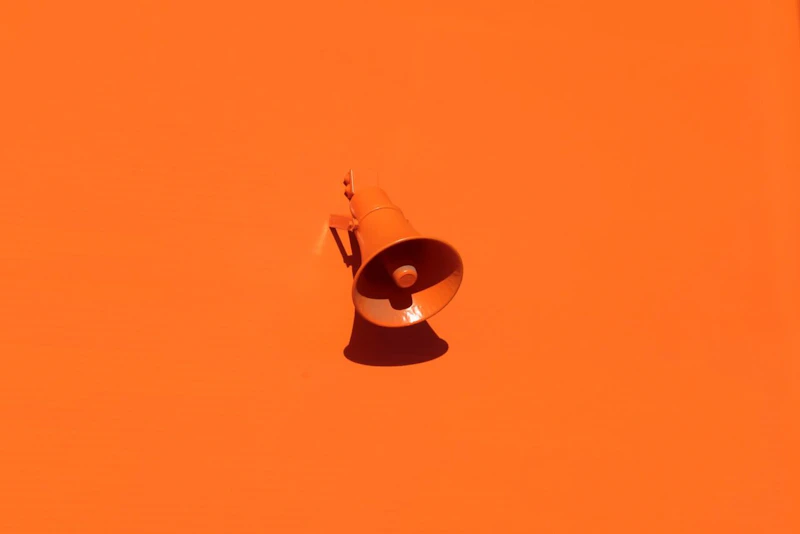 orange megaphone on orange wall