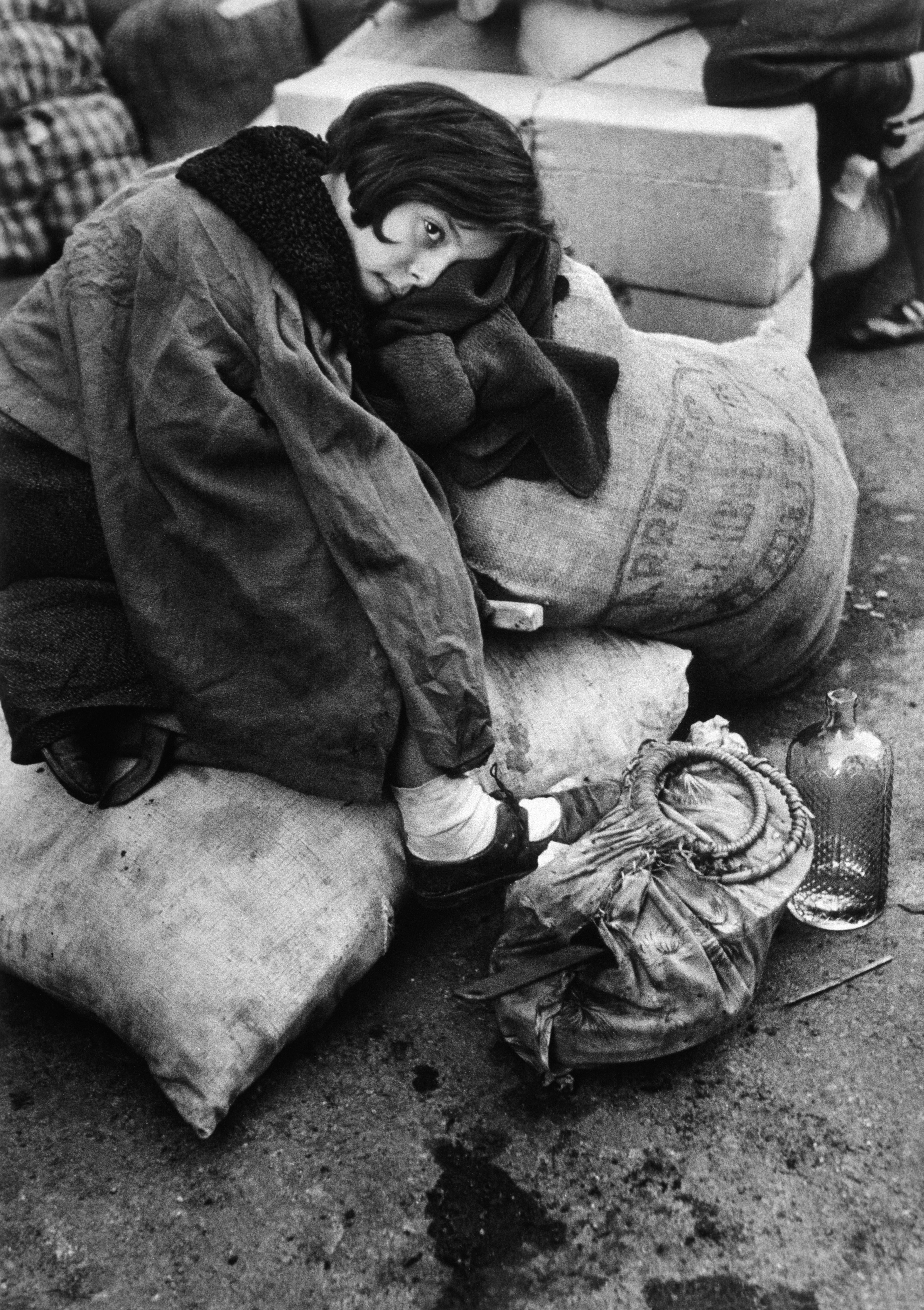 SPAIN. Barcelona. January 1939. Little girl resting during the evacuation of the city.