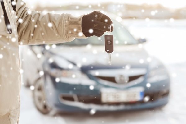 close up of man with car key outdoors