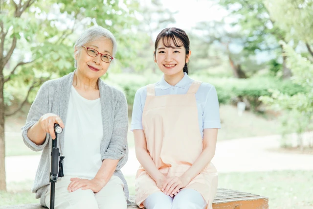微笑む女性と女性スタッフ
