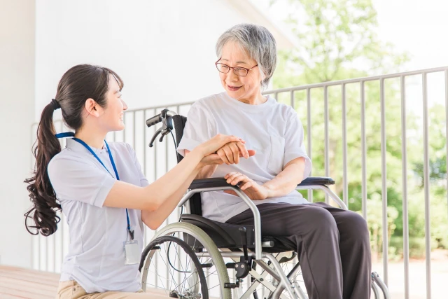 スタッフと車椅子の高齢女性