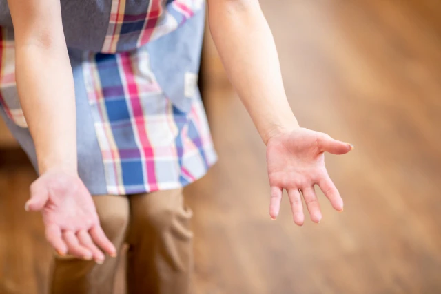 手を広げる保育士