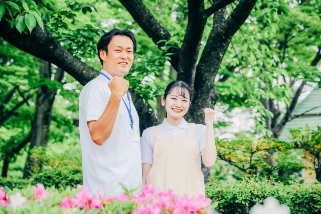 ガッツポーズをする男女の理学療法士