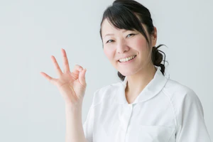 手をgoodにしている女性理学療法士
