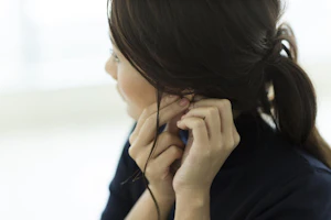 ピアスをつける女性