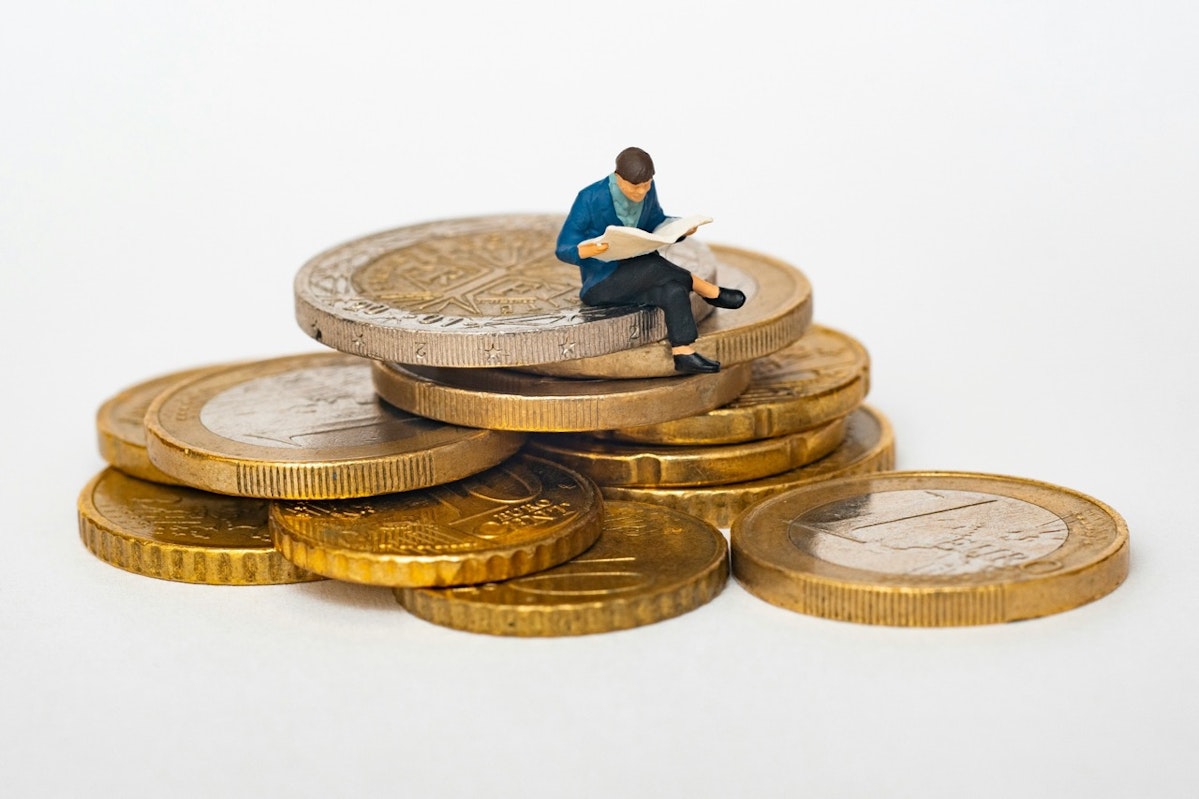お金の上に座る人