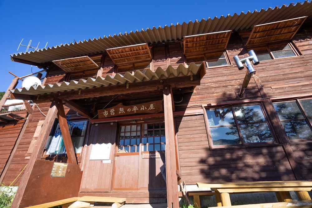 <p>熊の平小屋の前で小休止。<br>ぽかぽかと暖かい。前後は樹林帯に囲まれた、静かなところにある小屋だ。人も少ない。</p>