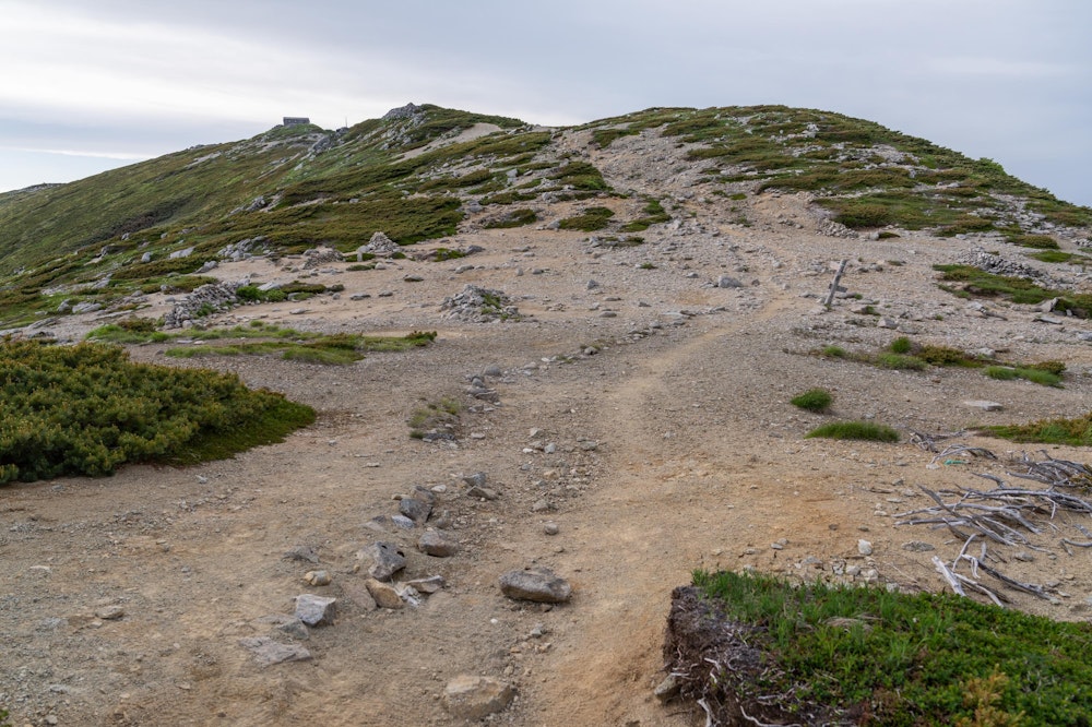 <p>最後の登りが体に堪えたが、本山小屋の手前の広場にたどり着いた。<br>小屋から少し離れるが、ここが広いテント場になっている。<br>見ての通り、今日は独り占め。本山小屋には数名の宿泊者がいるようだった。</p>