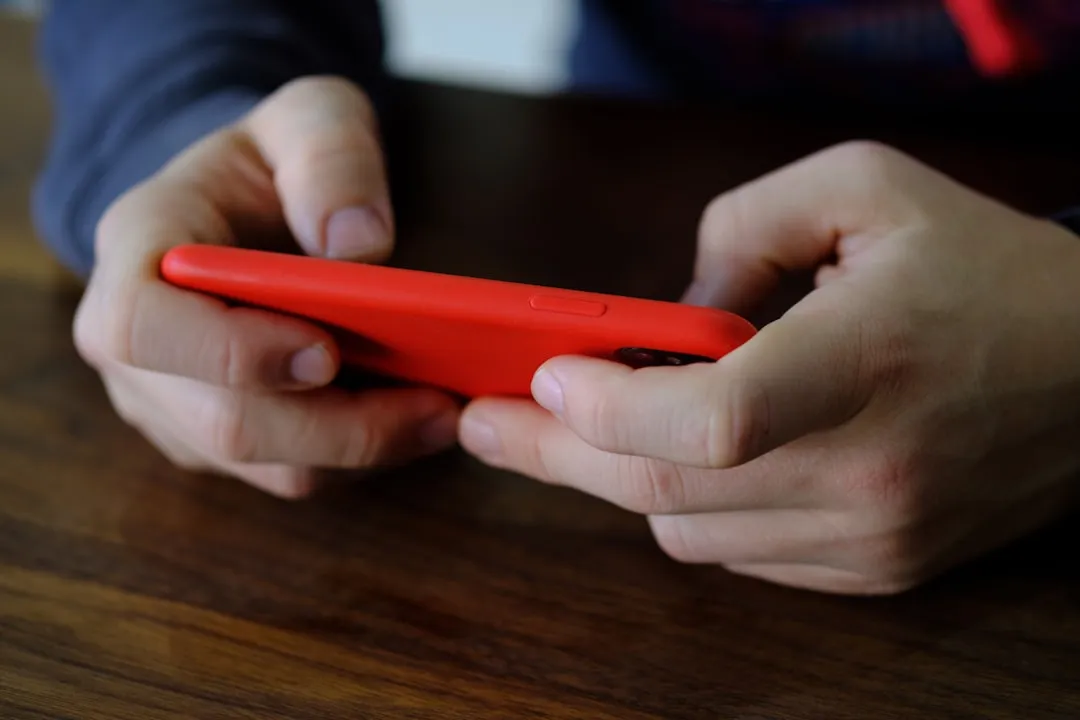 スマートフォンでゲームをプレイする若年層のイメージ
