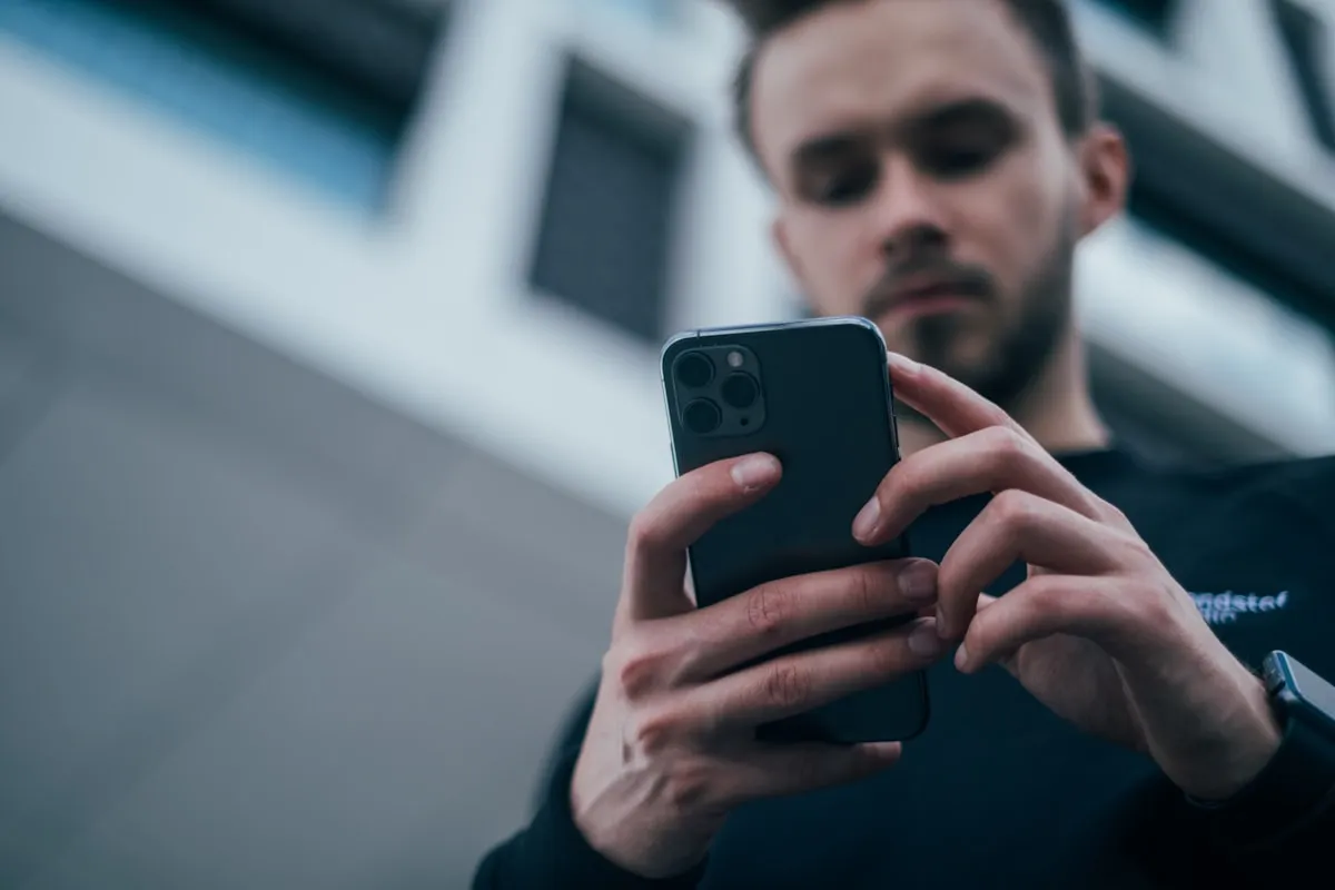 スマートフォンで推しの情報をチェックするZ世代の若者