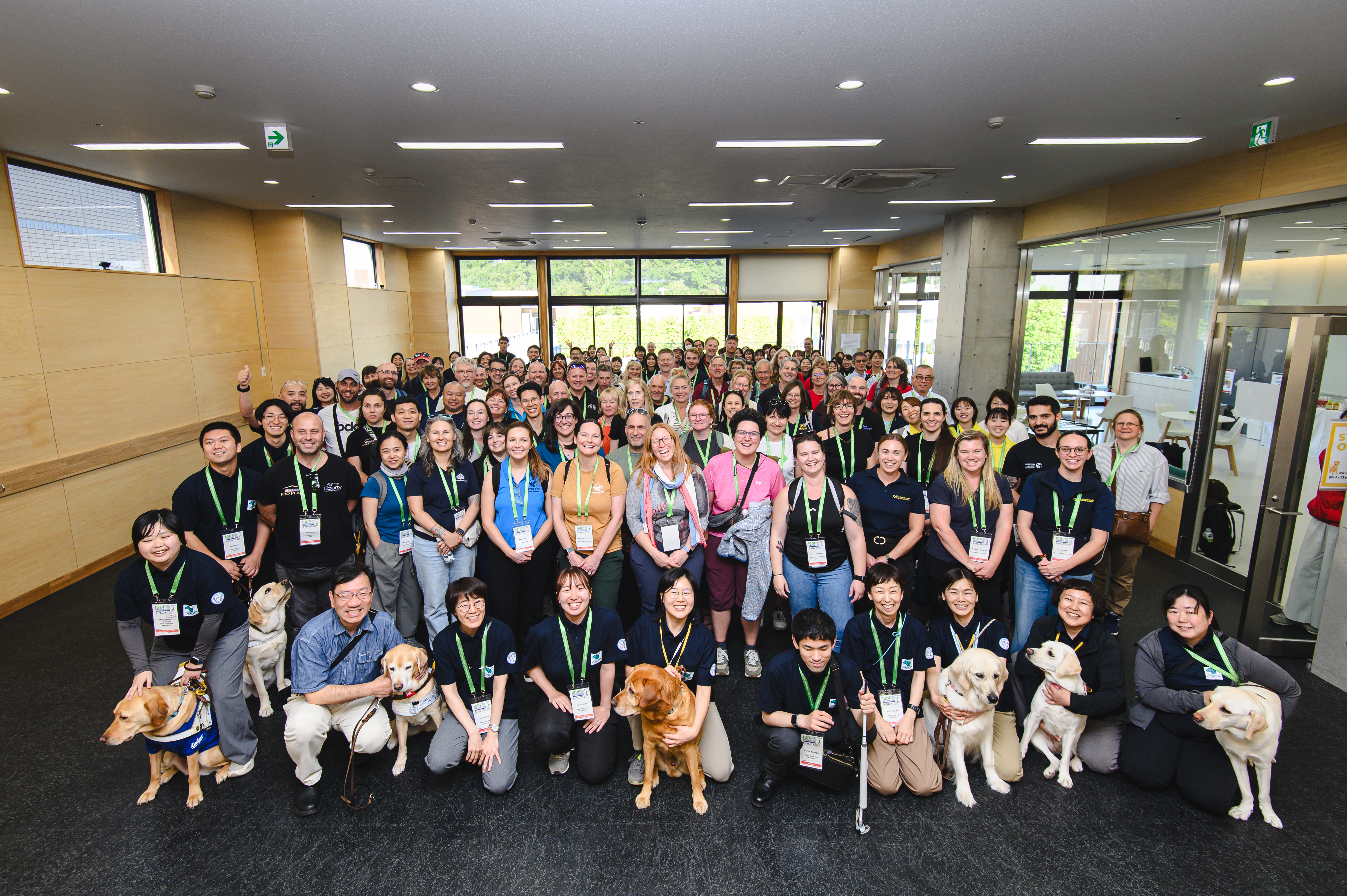 Group photo of tour attendees and staff at JGDA Kanagawa Training Center 