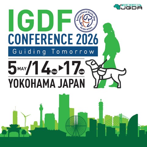 Key Visual of IGDF Conference.  Green silhouette of person with guide dog. Below the logo is  buildings of Yokohama also in green silhouette. 