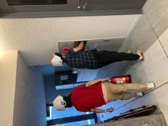 JGDA staff wearing a white collapsible helmet is heading somewhere with a fire extinguisher in her hand.