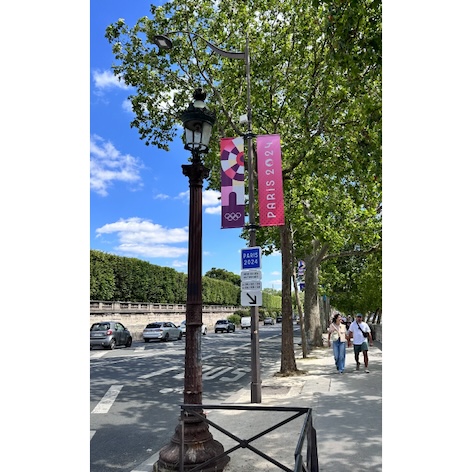 A photo of Paris Olympic banners displayed on the street.