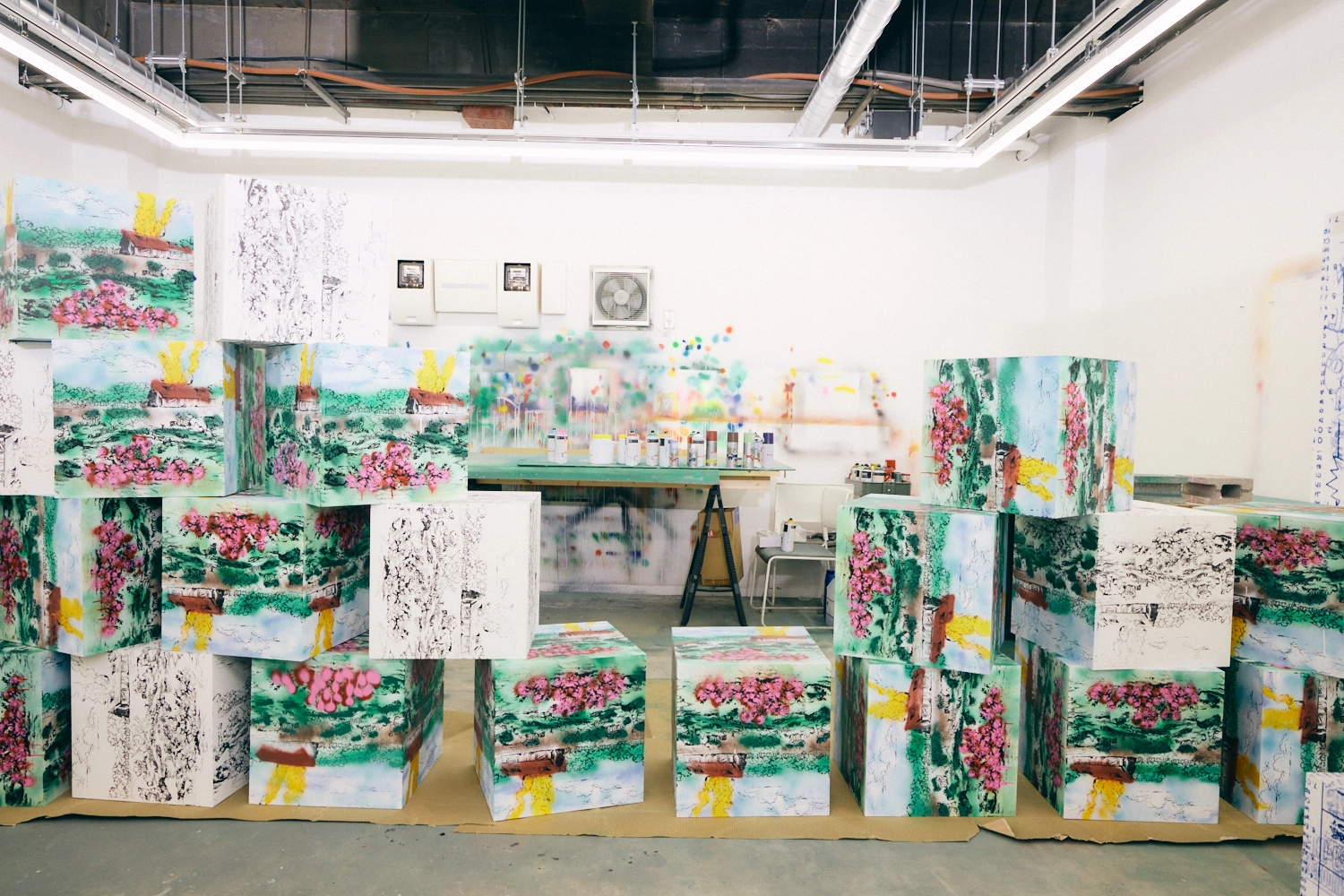 A photo of Hiroki Niimi's stacked cube artwork in his studio.