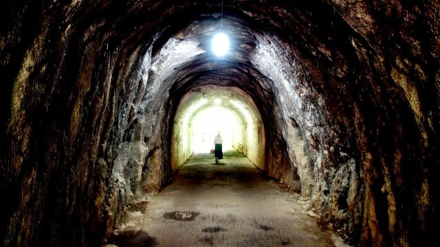トンネルの向こうへ消える女性