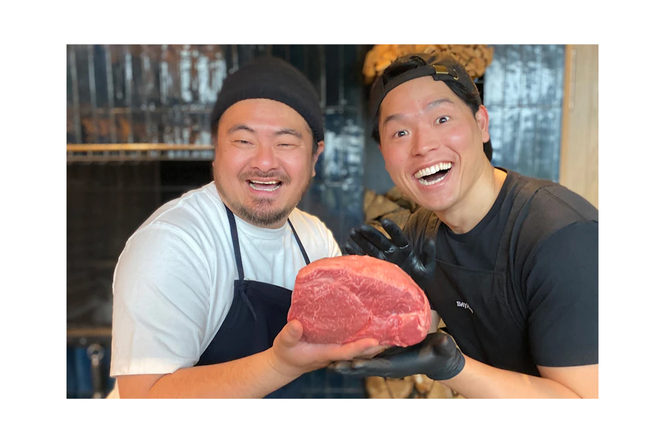 鳥羽シェフとバヤシさんが大きな肉を手に持ち笑顔の写真