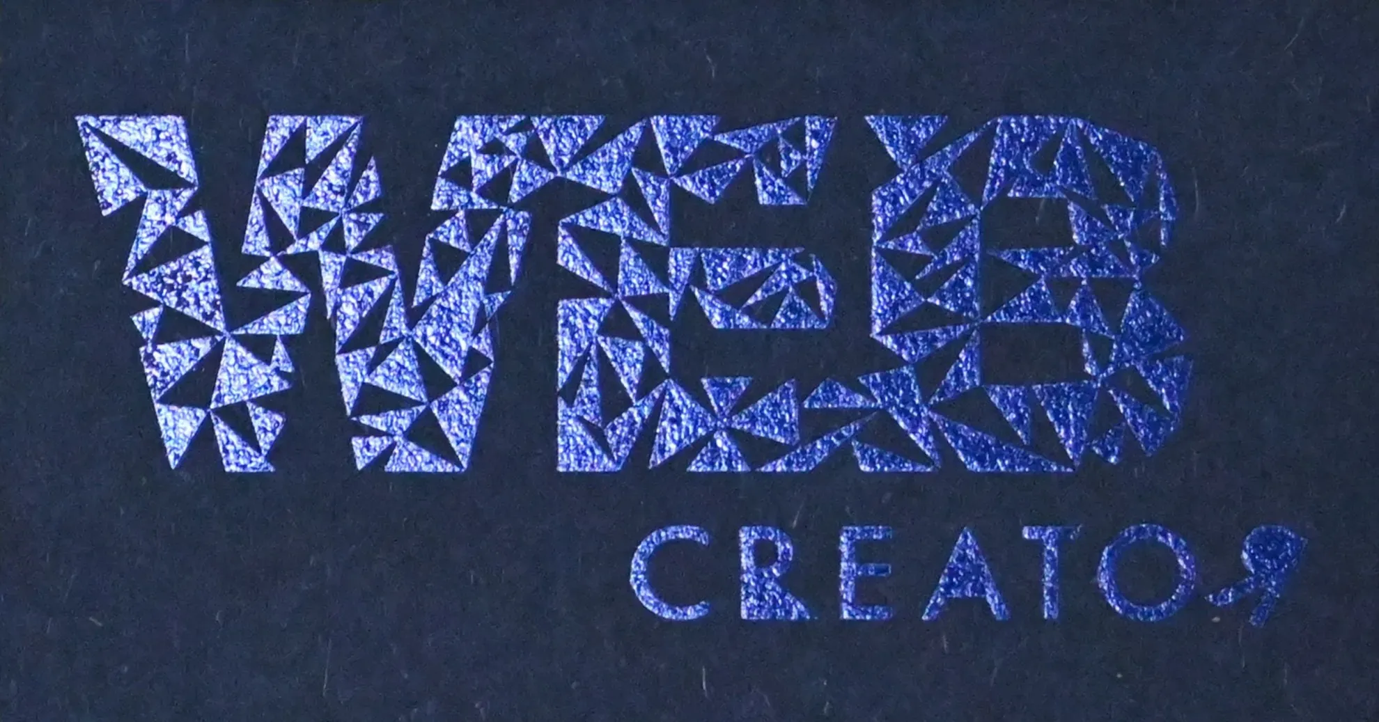 Triangular typography spelling 'WEB CREATOR' in navy foil