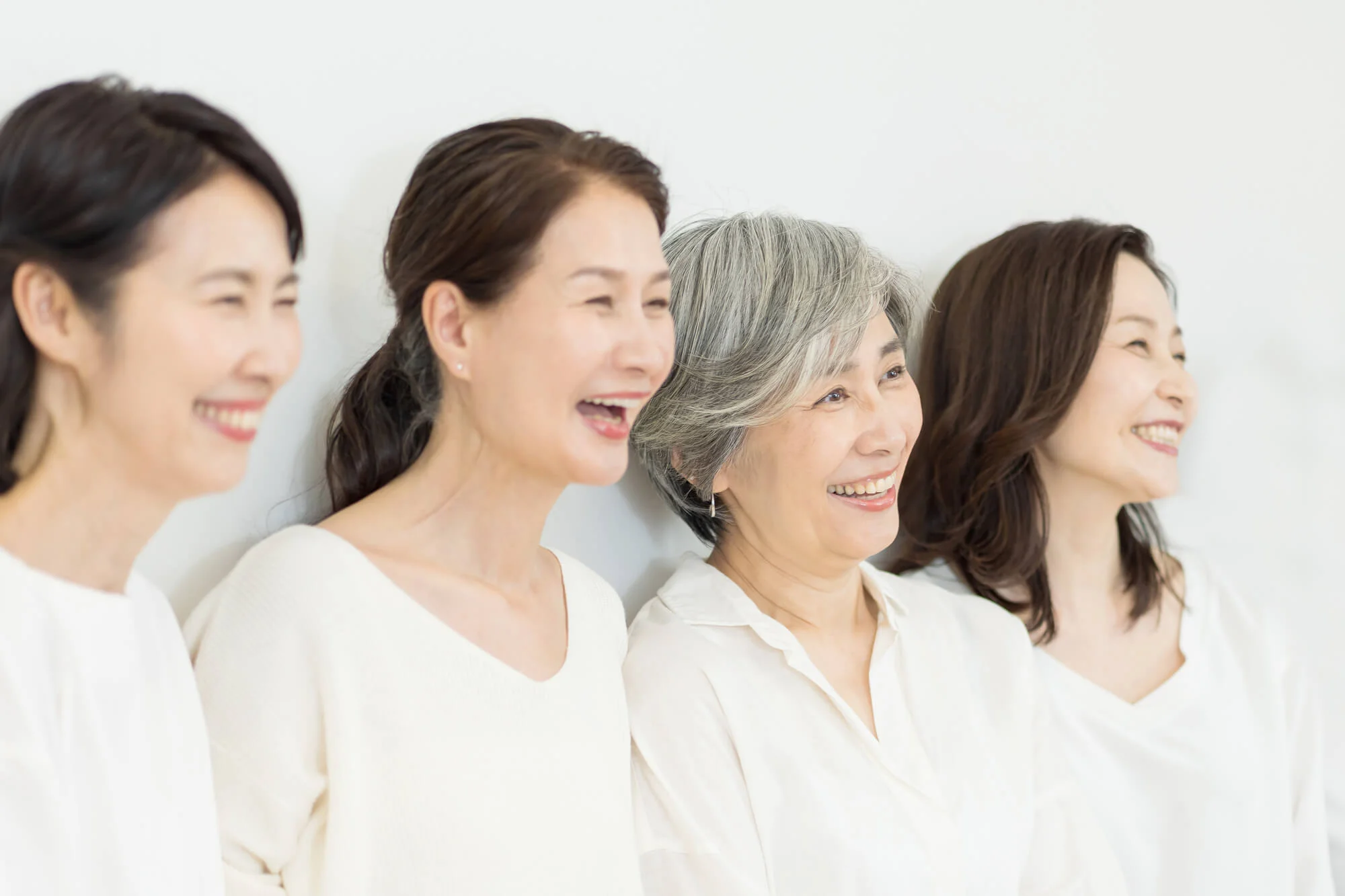 笑顔で並ぶさまざまな世代の女性4人
