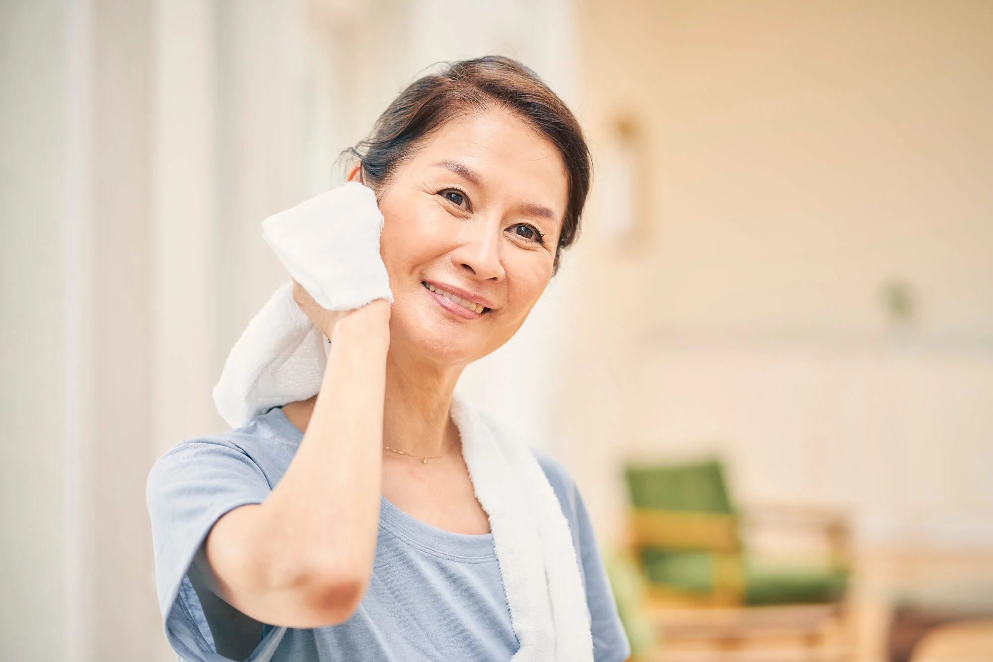 タオルで汗を拭う女性