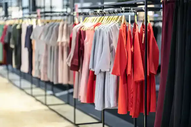Colorful of luxury Clothes hang on a shelf in Clothes store,Selective focus,Beauty and fashion concept