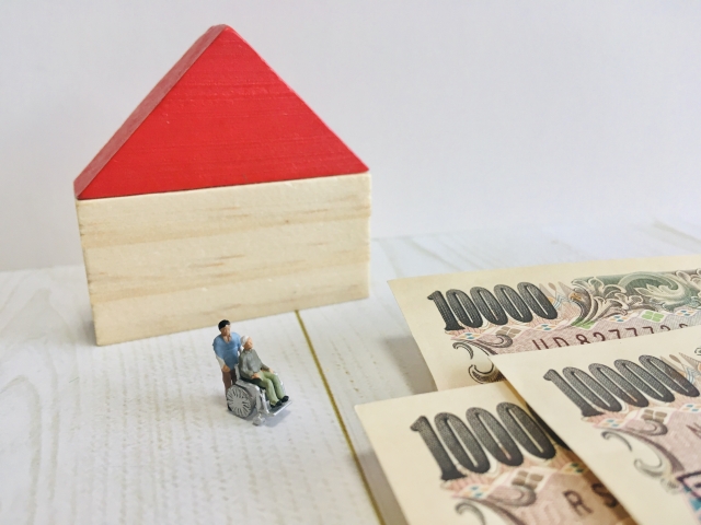 1万円札と車椅子の男性のイラスト