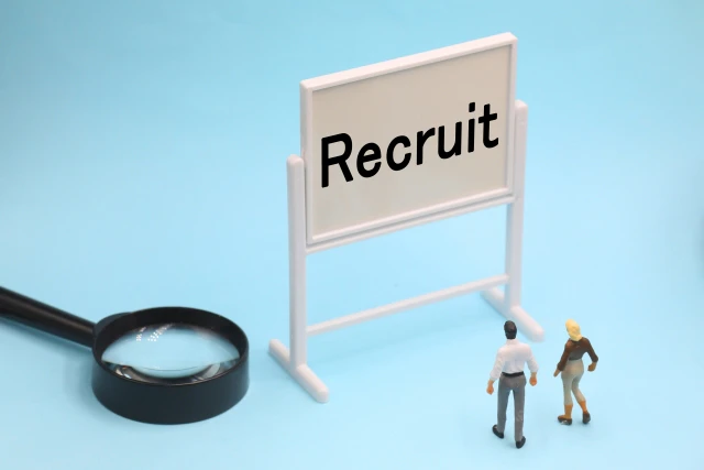 「リクルート」の文字をみる人と虫めがね