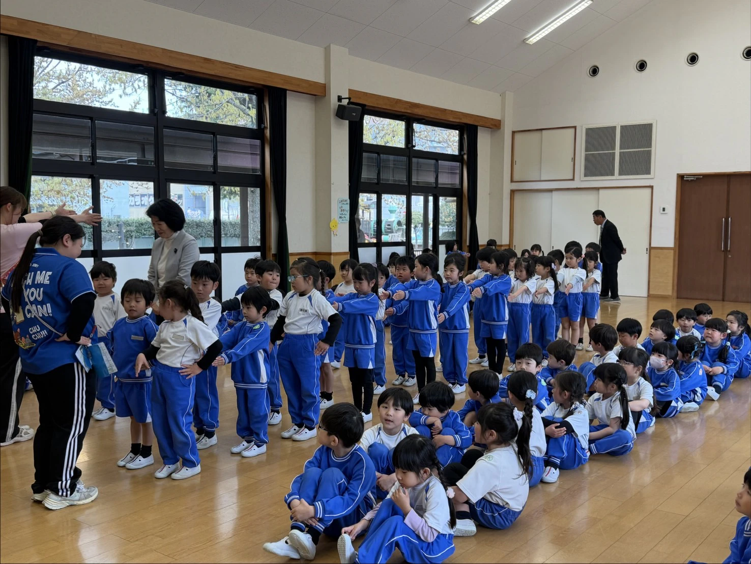 ホールで前ならえをする年長組
